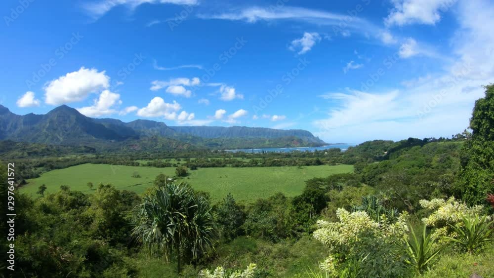 Wide angle overview of the lush green valley mountains and NaPali coast ocean waterfront in Hanalei Bay, Kauai Island/Hawaii Wide angle overview of the lush green valley mountains and NaPali coast ocean waterfront in Hanalei Bay, Kauai Island/Hawaii