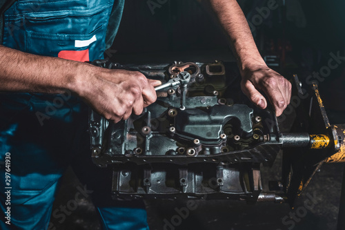 Auto mechanic repairing a car engine. Repair service in the garage.