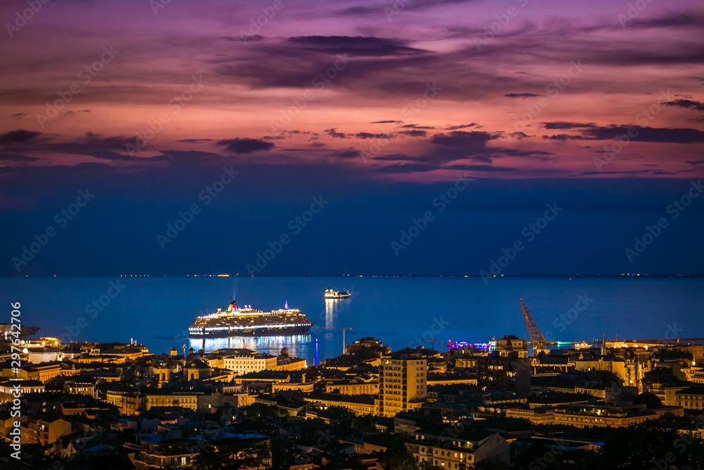 Harbor and cruise ship at colorful sunset in Trieste, Italy