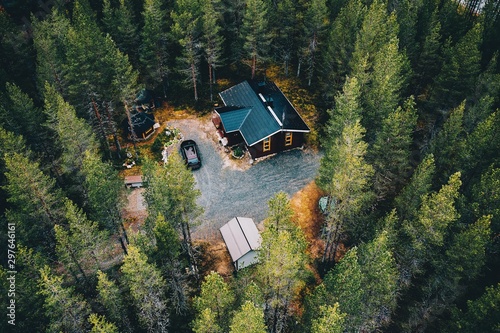 Schilderij op canvas Aerial view of secluded cottage in the woods