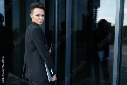 Young beautiful businesswoman posing against modern building