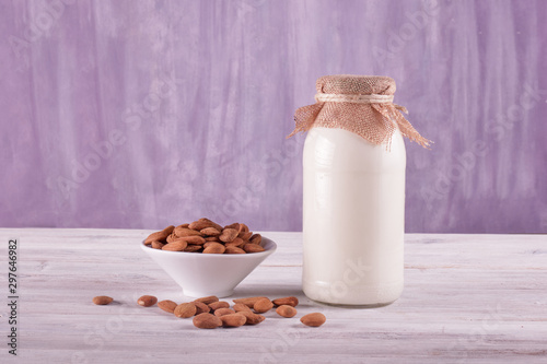 Bottle of almond milk on the wooden table	