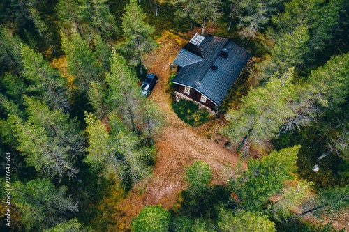 Aerial view of secluded cottage in the woods. Log cabin in the forest in rural Finland.