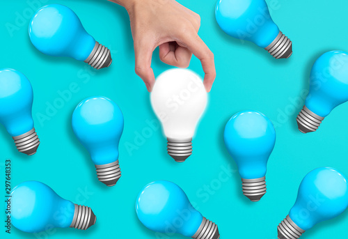 Business hand holding light bulb, concept of new ideas with innovation and creativity.