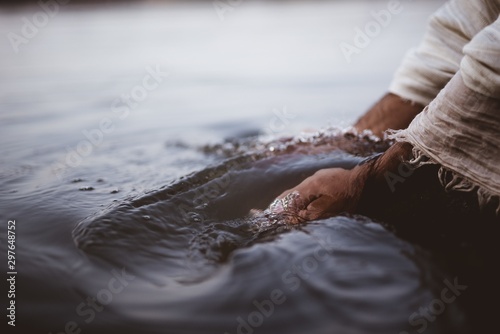 Foto Closeup shot of a person wearing a biblical robe while washing his hands in the