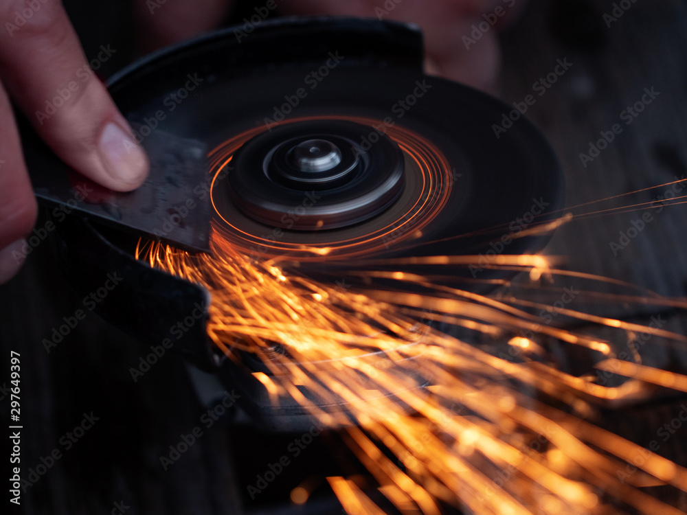 Man sharpen axe by grinder in the dark with sparks Stock Photo | Adobe Stock