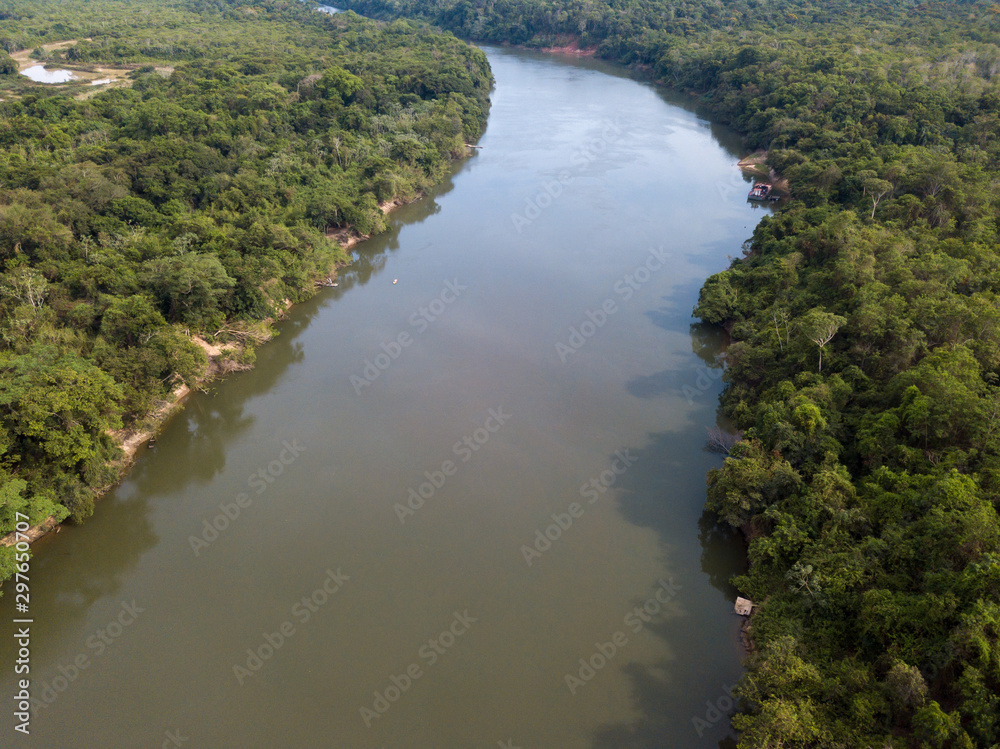 Beautiful aerial drone view of Rio Teles Pires and Amazon rainforest on sunny summer day near Sinop city, Mato Grosso, Brazil. Concept of climate change, conservation and natural resources.