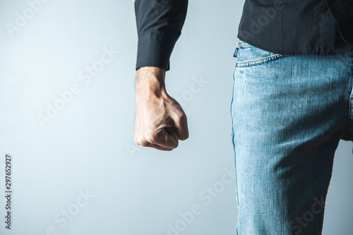 angry man fist on gray wall background photo