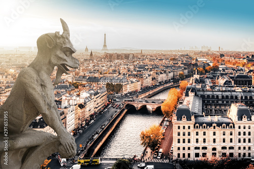Famous Notre Dame gargoyle overlooking the Paris cityscape with Eiffel Tower in the background.