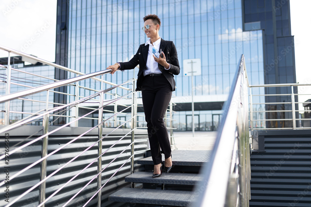 Young beautiful businesswoman posing against modern building Young beautiful businesswoman posing against modern building