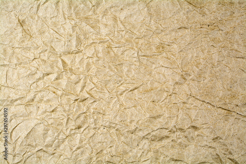Background from crumpled paper of brown color.