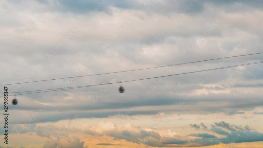 Timelapse - fast moving gondola lift cable car system - aerial rope transit. Daylight, cloudy day. Moving clouds against sunset sky. Time lapse, tourism, sightseeing, public tansportation concept Timelapse - fast moving gondola lift cable car system - aerial rope transit. Daylight, cloudy day. Moving clouds against sunset sky. Time lapse, tourism, sightseeing, public tansportation concept