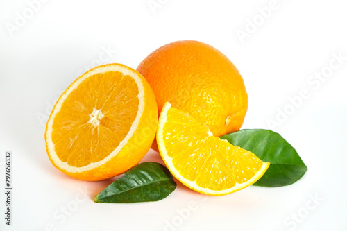 Close up image of juicy organic whole and halved oranges with green leaves   visible core texture  isolated white background  copy space. Macro shot of bright citrus fruit slices. Top view  flat lay.