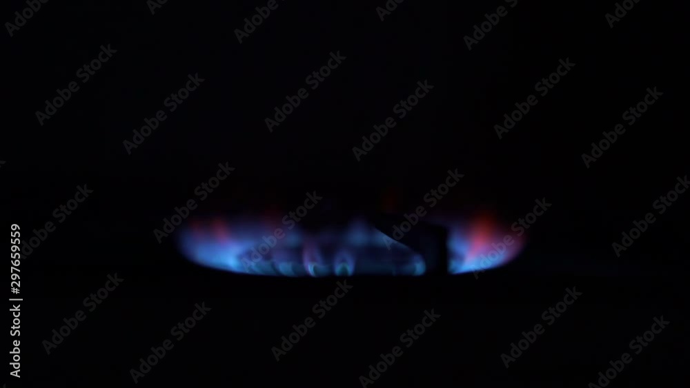 stove burner turned on among dark kitchen delivers blue gas with bright orange red sparks extreme close view stove burner turned on among dark kitchen delivers blue gas with bright orange red sparks extreme close view