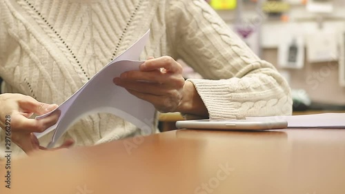Close up female hands tearing sheets paper