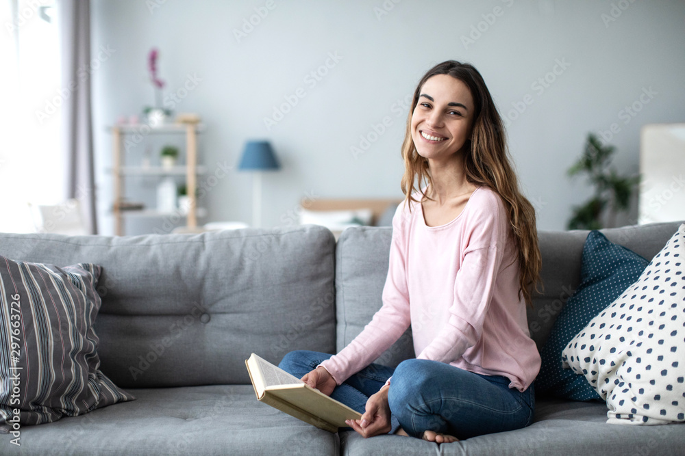 Beautiful female with a book and smiling looking camera. Beautiful female with a book and smiling looking camera.