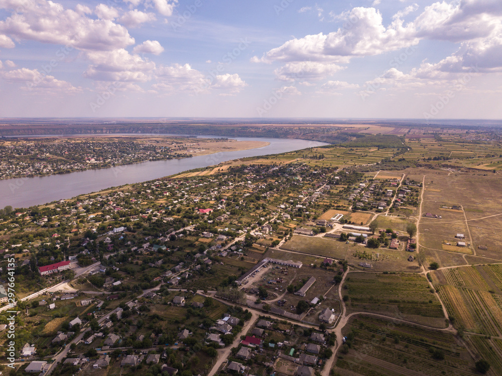Arial view over the river and small village in autumn. Moldova republic of. Molovata village. River Dniester.