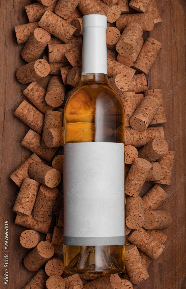 Template of white glass bottle of wine on corks and wood background. Poster concept design photo shooting Template of white glass bottle of wine on corks and wood background. Poster concept design photo shooting