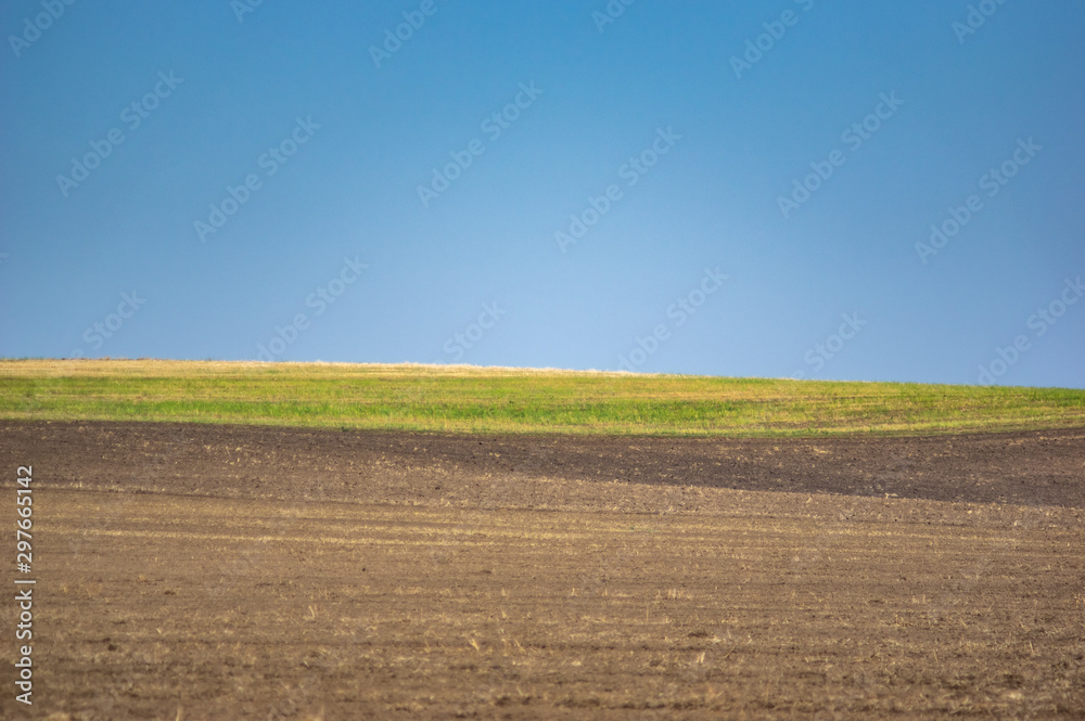 Plowed land on a field of black soil Plowed land on a field of black soil