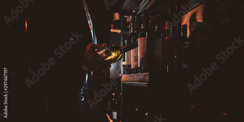 Vászonkép Expirienced wine sommelier is choosing good wine for tasting at private wine cellar