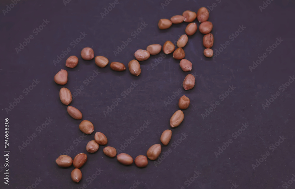 Valentine's day concept: Beautiful heart of the peanuts on the black background. Symbol of lovers. Valentine's day concept: Beautiful heart of the peanuts on the black background. Symbol of lovers.