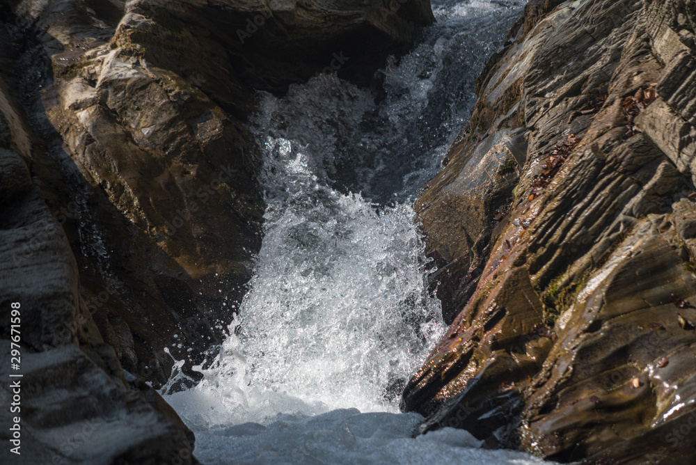The flow of water between stones in a mountain river The flow of water between stones in a mountain river