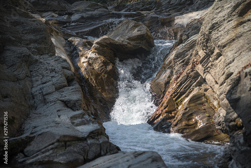 The flow of water between stones in a mountain river