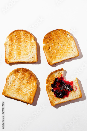 Toasted bread with tasty jam isolated on a white background.Healthy fashion food background with hard shadows.Breakfast brunch concept.Top view,flat lay.Vertical orientation
