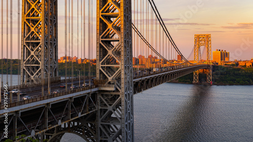 The George Washington Bridge (long-span suspension bridge) across the Hudson River at sunset. Uptown and Fort Washington Park, New York City, USA