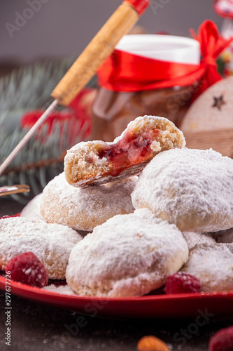 Traditional Christmas cookies biscuits snowballs covered icing sugar povder with almond nut, nutella chocolate an raspberry jam. Christmas New Year ornament decorations. photo