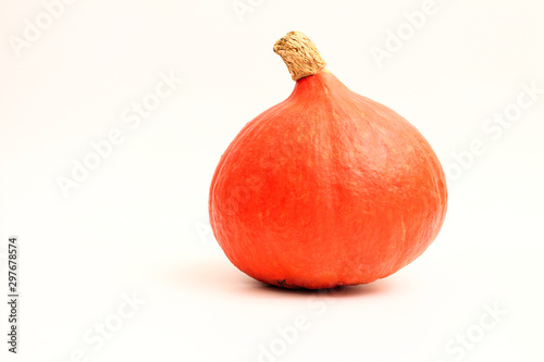 Isolated red kuri squash on a white background. Side view of a small pumpkin without the ridges. photo