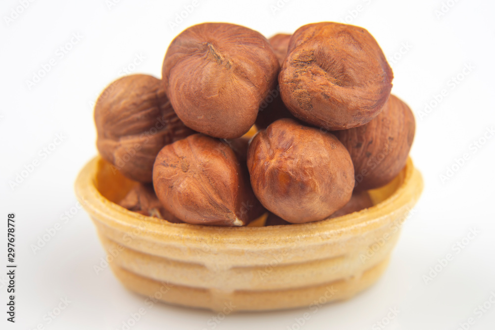 Different nuts in a waffle basket on a white background. Vitamin wholesome food. Different nuts in a waffle basket on a white background. Vitamin wholesome food.