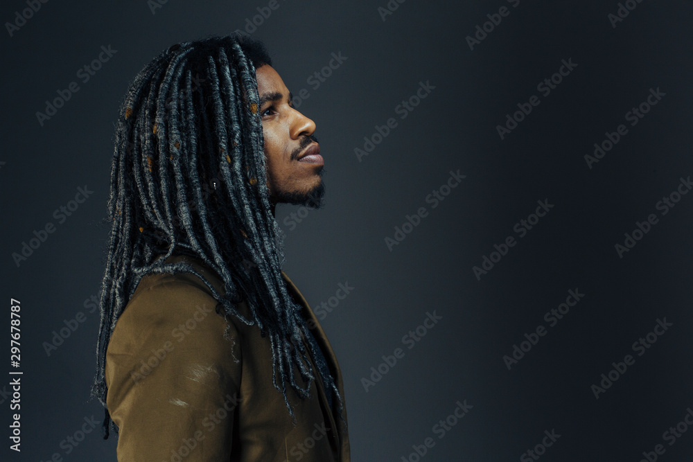 Profile portrait of a young man with cool hair looking up in studio Profile portrait of a young man with cool hair looking up in studio