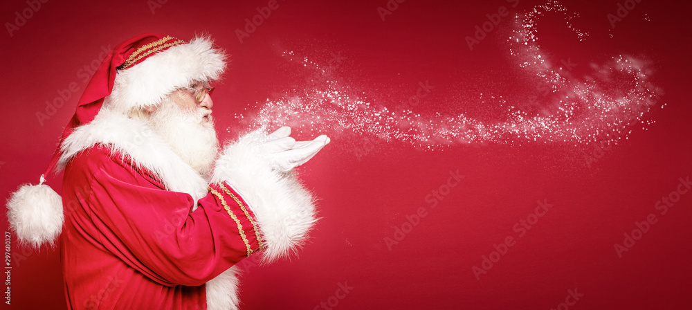 Real Santa Claus on red studio background. - obrazy, fototapety, plakaty 