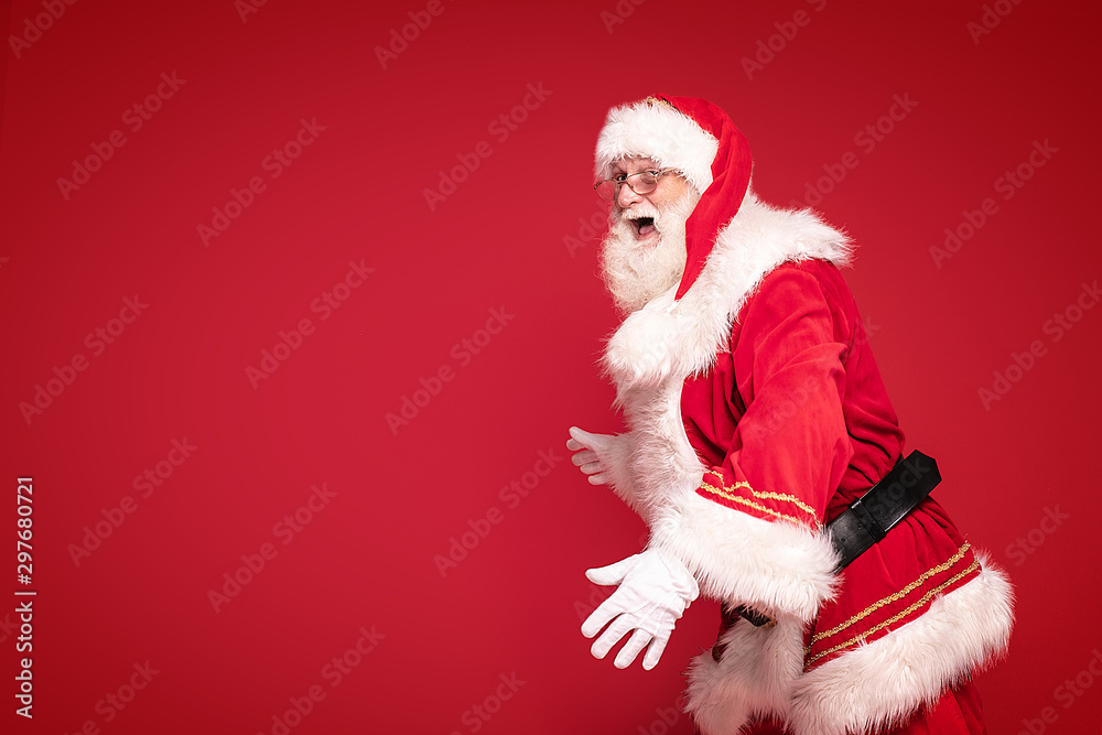Happy Santa Claus on red studio background. Happy Santa Claus on red studio background.