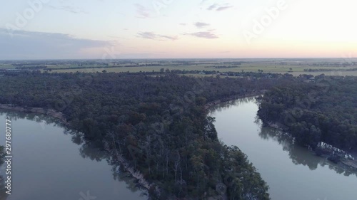 Backward flight over Murray River at dusk in NSW, Australia photo