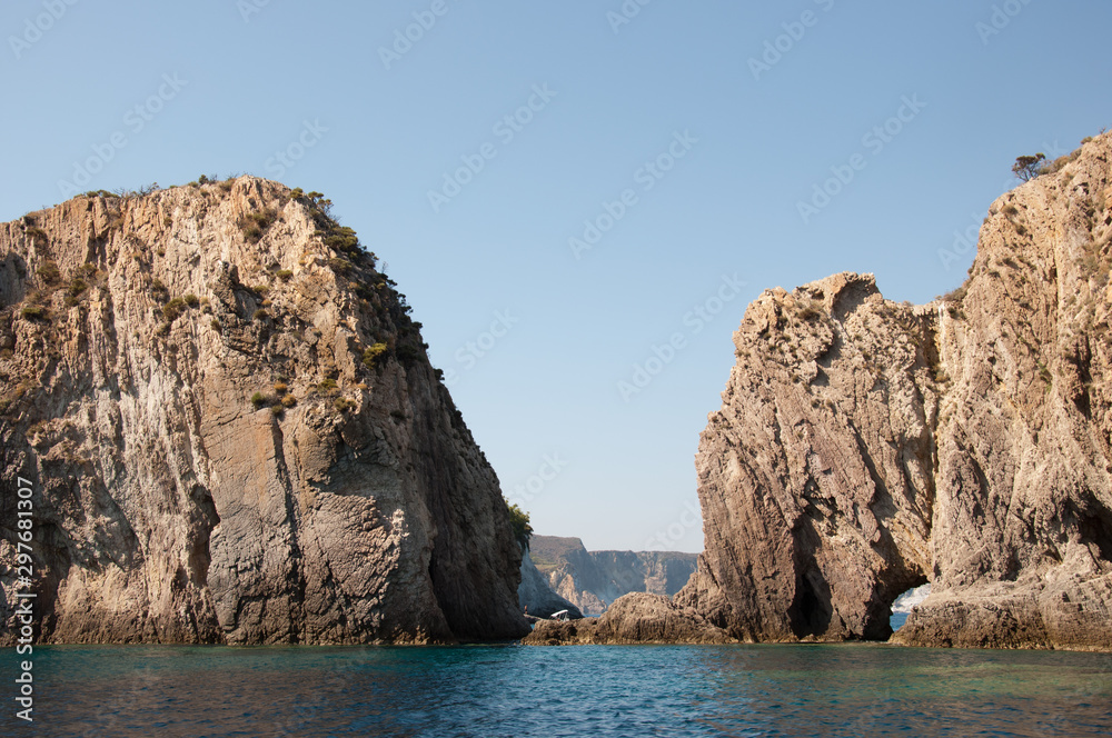 Passage berween the rocks in the sea. Rocky cliff (Faraglioni della Madonna) of the mediterranean sea of the island of Ponza in Italy.