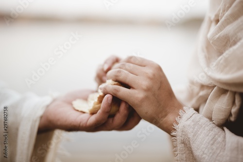 Fototapete Biblical scene - of Jesus Christ handing out bread wit ha blurred background
