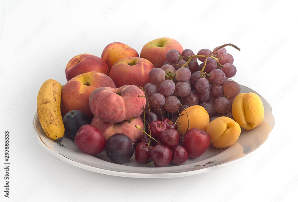Isolate.Porcelain plate on a white background.On a plate lie juicy ripe fruit Isolate.Porcelain plate on a white background.On a plate lie juicy ripe fruit