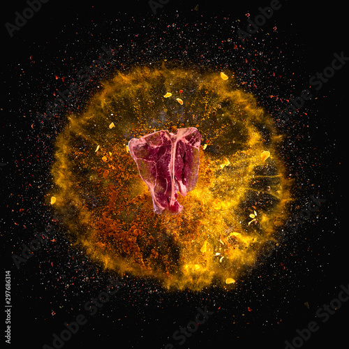 Fototapeta Naklejka Na Ścianę i Meble -  Hot red pepper, garlic, different spices powder meat stakes flying on a black background Motion freeze photo composition