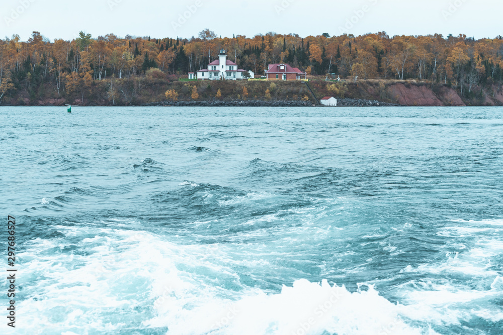 Raspberry Island Lighthouse in Wisconsin on Lake Superior in the Apostle Islands National Lakeshore - wake of the boat in foreground