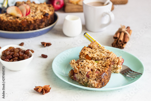 Oatmeal cake or baked oatmeal with apples and raisin. Dietary autumn pastries, healthy breakfast. 