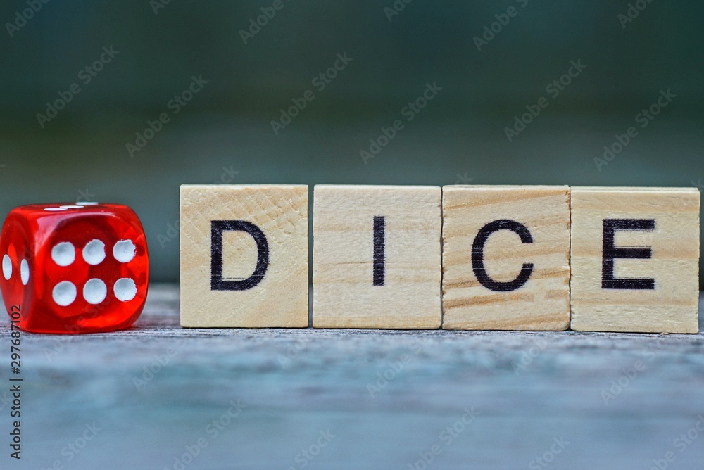 Fototapeta word made of wooden letters and red dice on a gray table