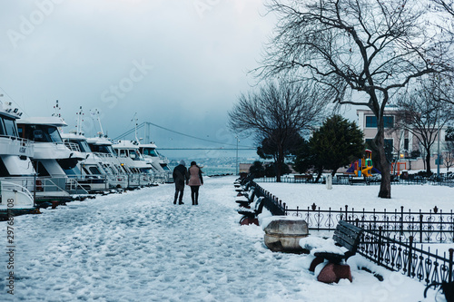 Canvas Print Istanbul, Uskudar / Turkey - 15Feb2015: a couple walking by the seaside with hol