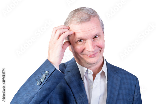 An elderly man in a suit is thoughtful and put his hand to his temple. Isolated on a white background.