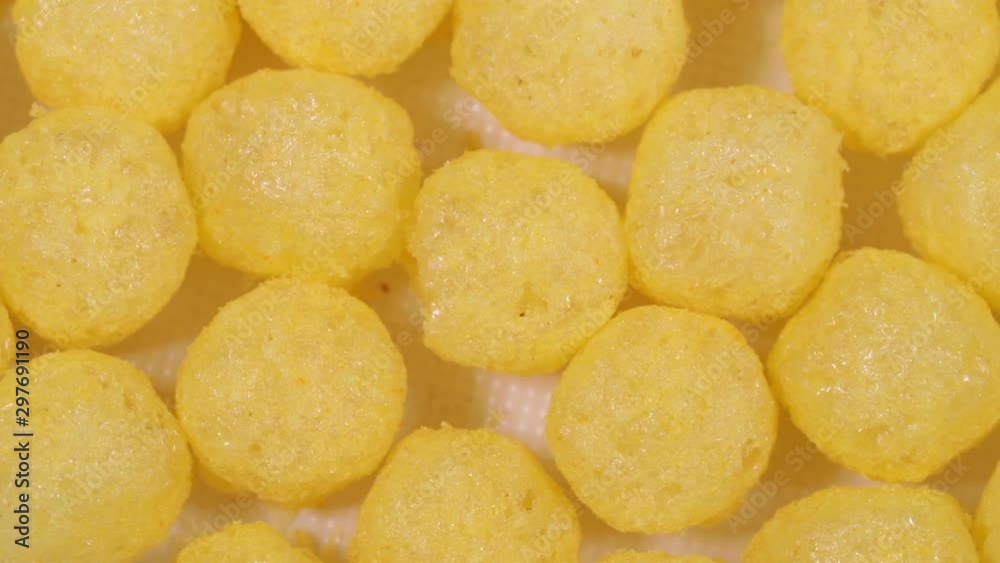 yellow round corn balls spinning slowly. macro background yellow round corn balls spinning slowly. macro background