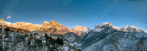 Pruno little village in the apuan alps in tuscany, snowy day with beautiful golden sunset, on the right top view the famous 