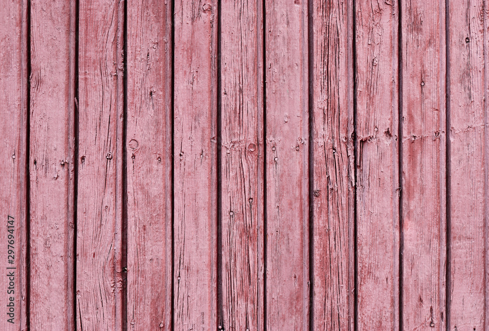 Painted old wooden wall. Red background. Vertical direction of the boards. Painted old wooden wall. Red background. Vertical direction of the boards.