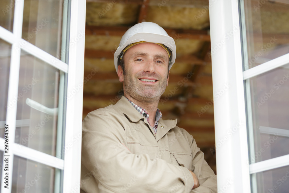 construction worker stood at open windows construction worker stood at open windows