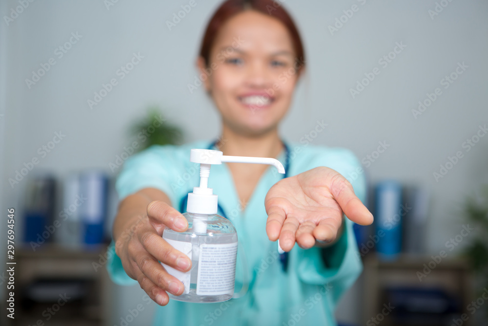 female doctors hands using sanitizer dispenser female doctors hands using sanitizer dispenser